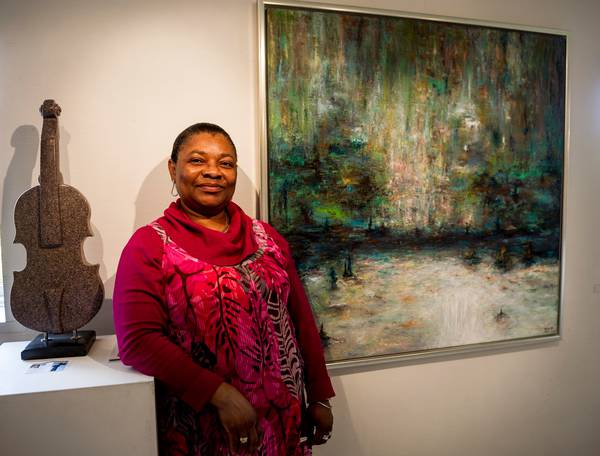 Eme O. Willie In front of her painting during exibition